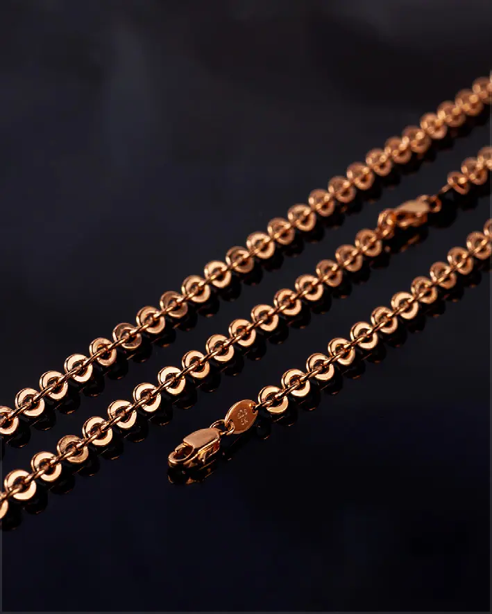 Gold chain on a dark surface