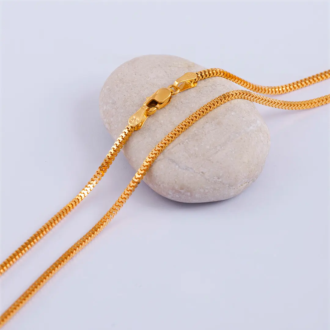Gold necklace on a stone